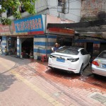 Automotive industries.  Look closely to see a man using a bucket and some bamboo as a giant bong.