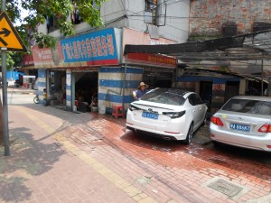 Automotive industries.  Look closely to see a man using a bucket and some bamboo as a giant bong.